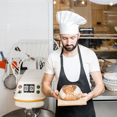 Baker with bread in the bakery (Demo)